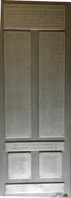 A plaque that lists alumni who donated to five statues on the facade of Harkins Hall.