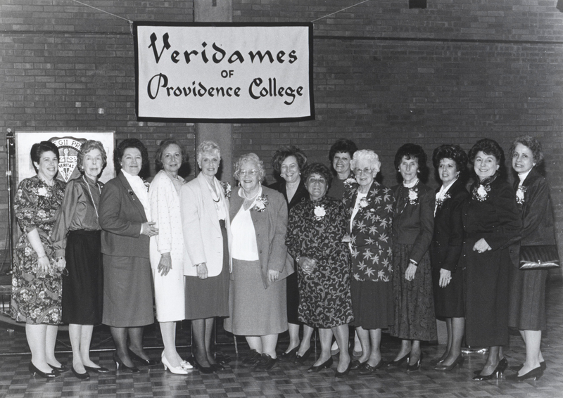 Several women pose for a photo under a banner that reads 'Providence College Veridames.'