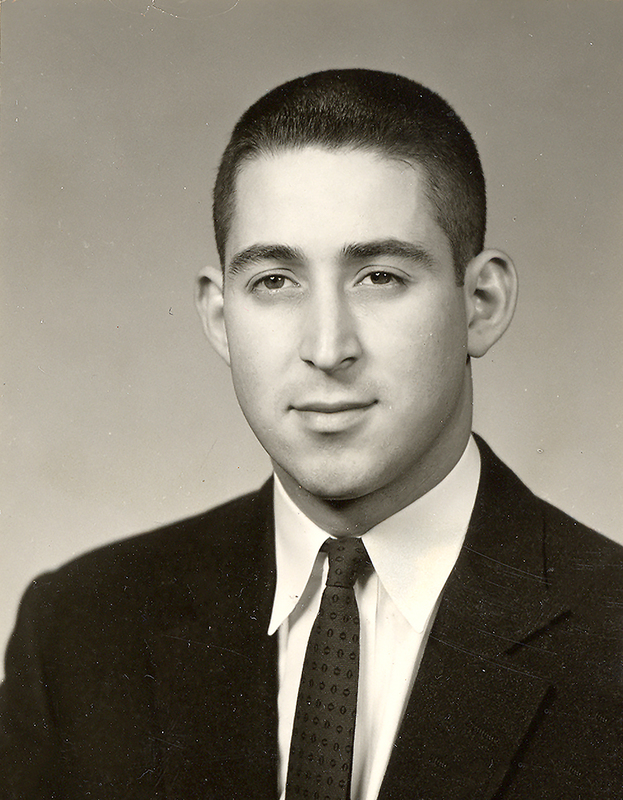 Portrait of Howard Lipsey wearing a suit and tie in front of a light background.