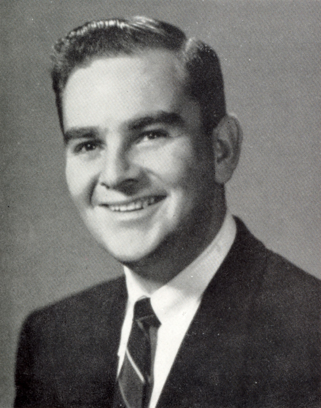 Portrait of Bertram Forman wearing a suit and tie in front of a light background.