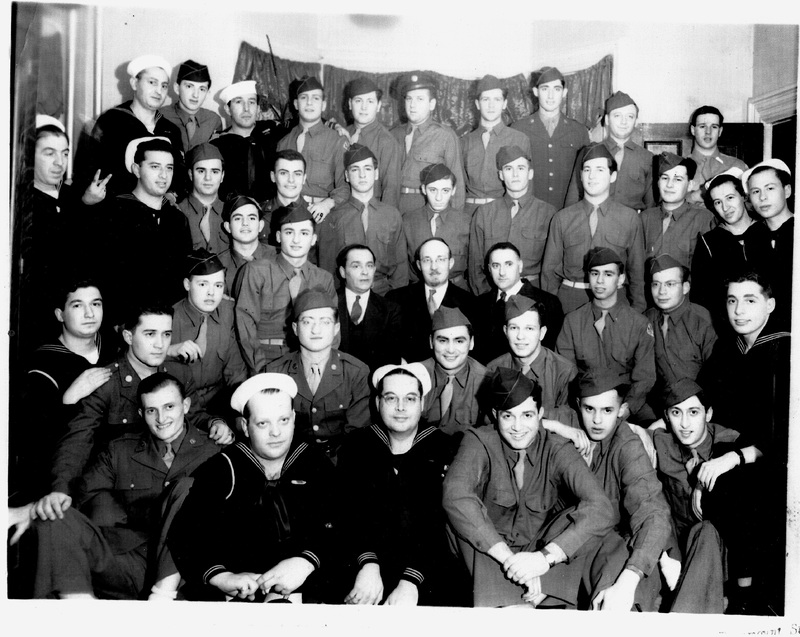 A group of about 40 uniformed military personnel, including soldiers and sailors, posed in rows with a curtain backdrop.