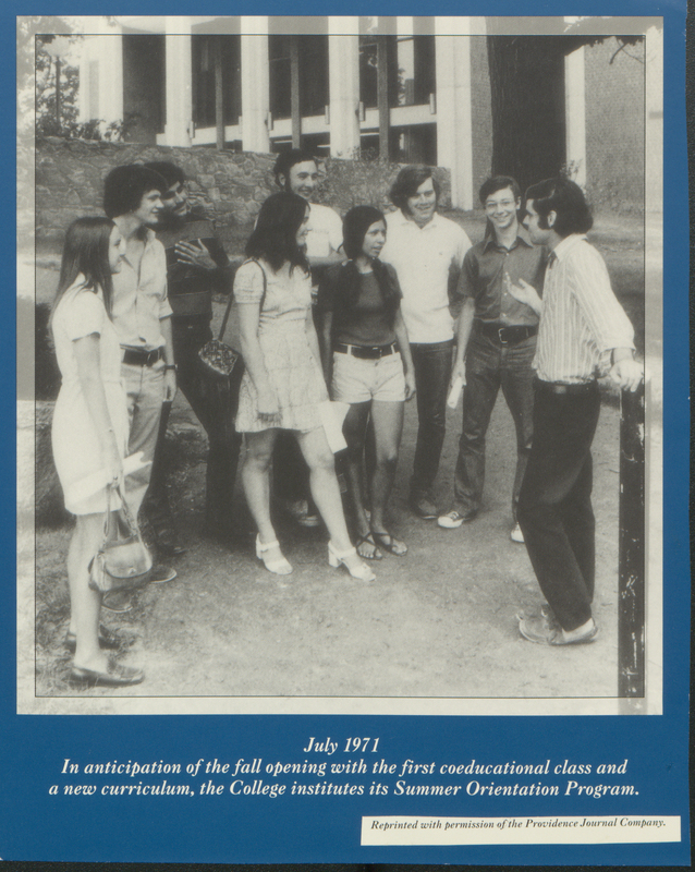 A group of young people, both men and women, standing outside a building talking to one another. The photograph is part of a display about the college's Summer Orientation Program, highlighting the anticipation of the fall opening with the first coeducational class and new curriculum at the college.