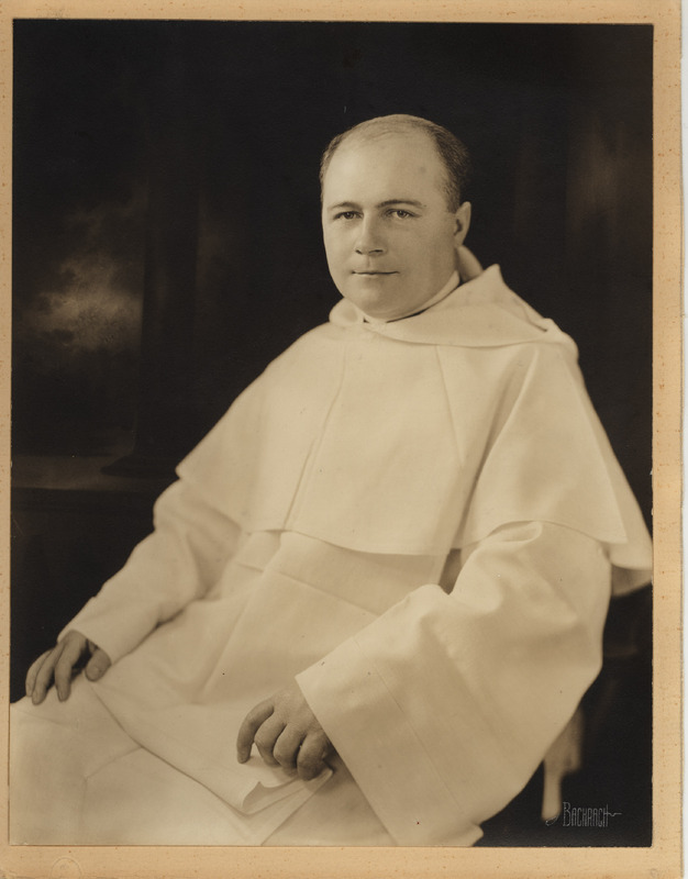 Seated portrait of Rev. John Jordan Dillon wearing a white habbit in front of a dark background.