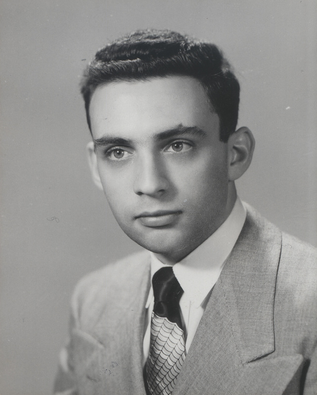 Portrait of Robert Krasner in a light-colored suit jacket, white shirt, and patterned tie.