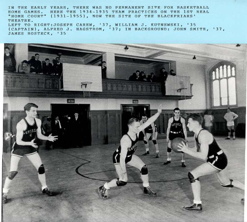The 1934–1935 basketball team practicing in a gym with wooden floors, and spectators on an upper balcony.
