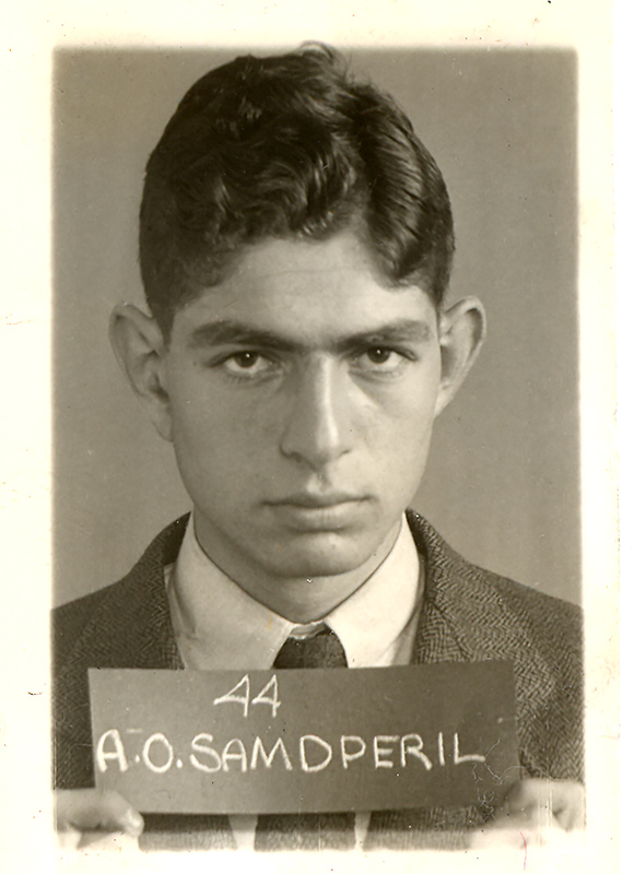 Portrait of Alfred Samdperil wearing a suit and tie posing in front of a light background.