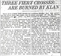 Newspaper clipping with the headline 'THREE FIERY CROSSES ARE BURNED BY KLAN,' reporting Ku Klux Klan cross burnings in Providence and East Providence.