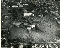 Providence College campus circa 1939, featuring multiple buildings, open fields, and a circular driveway, set within a suburban neighborhood.