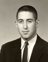 Portrait of Howard Lipsey wearing a suit and tie in front of a light background.