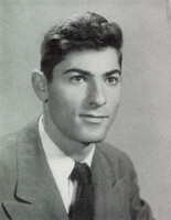 Portrait of Henry Levin wearing a suit and tie in front of a light background.