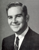 Portrait of Bertram Forman wearing a suit and tie in front of a light background.