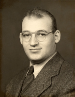 Portrait of Samuel Katznelson wearing glasses, a suit jacket, collared shirt, and tie.