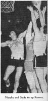 A basketball game with three players jumping near the basket, including one in a 'Providence' jersey with number 15 and another in jersey number 9.