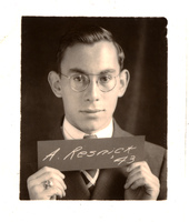 Portrait of Albert Resnick in glasses, suit, and tie holding a sign that reads 'A. Resnick, '43'.