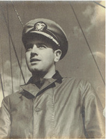 Photo of Aaron Slom in a military uniform and peaked cap, standing in front of ship rigging under a cloudy sky.