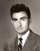 Portrait of Herbert Leshinsky wearing a suit and tie in front of a light background.