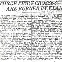 Newspaper clipping with the headline 'THREE FIERY CROSSES ARE BURNED BY KLAN,' reporting Ku Klux Klan cross burnings in Providence and East Providence.