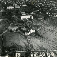 Providence College campus circa 1939, featuring multiple buildings, open fields, and a circular driveway, set within a suburban neighborhood.