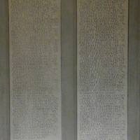 A plaque that lists alumni who donated to five statues on the facade of Harkins Hall.
