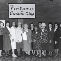Several women pose for a photo under a banner that reads 'Providence College Veridames.'