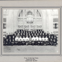 The first entering class on Opening Day, September 18, 1919, posed in front of a Gothic-style building entrance, with individuals dressed formally in suits and ties.