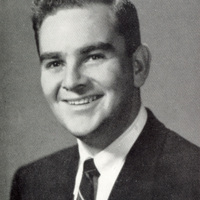 Portrait of Bertram Forman wearing a suit and tie in front of a light background.