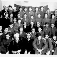 A group of about 40 uniformed military personnel, including soldiers and sailors, posed in rows with a curtain backdrop.