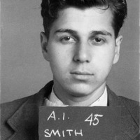 Portrait of Abraham Smith wearing a suit and holding a sign that reads 'A.I. 45 SMITH,' with a plain background.