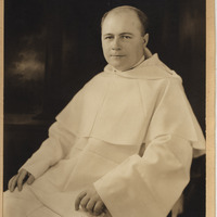 Seated portrait of Rev. John Jordan Dillon wearing a white habbit in front of a dark background.