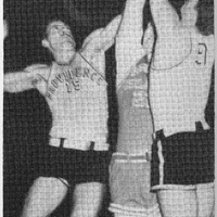 A basketball game with three players jumping near the basket, including one in a 'Providence' jersey with number 15 and another in jersey number 9.