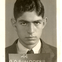 Portrait of Alfred Samdperil wearing a suit and tie posing in front of a light background.